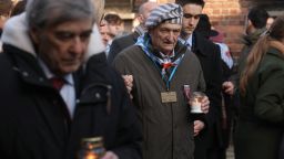 Survivors of Auschwitz and their families arrive to lay candles at the concentration camp's so-called "death wall" on the 80th anniversary of the liberation.