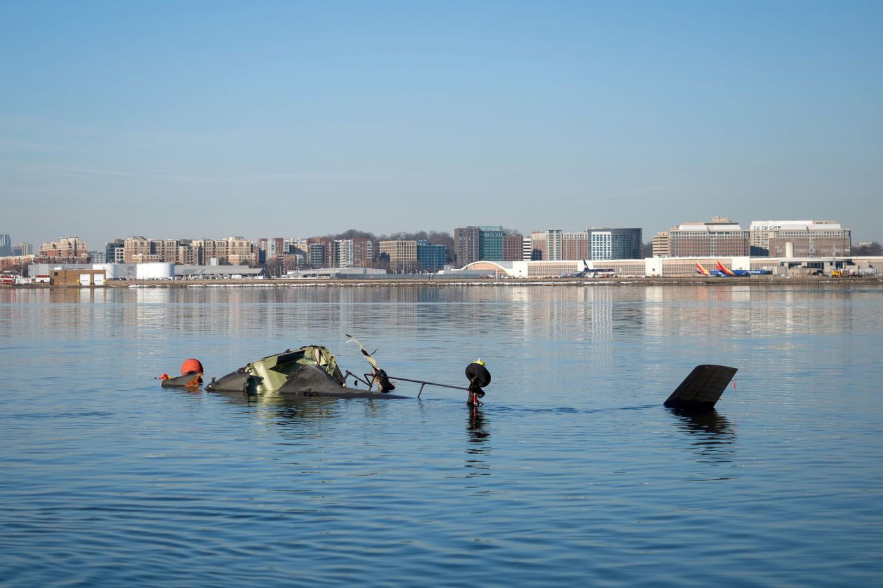 The Coast Guard investigates aircraft wreckage on the Potomac River on Thursday.