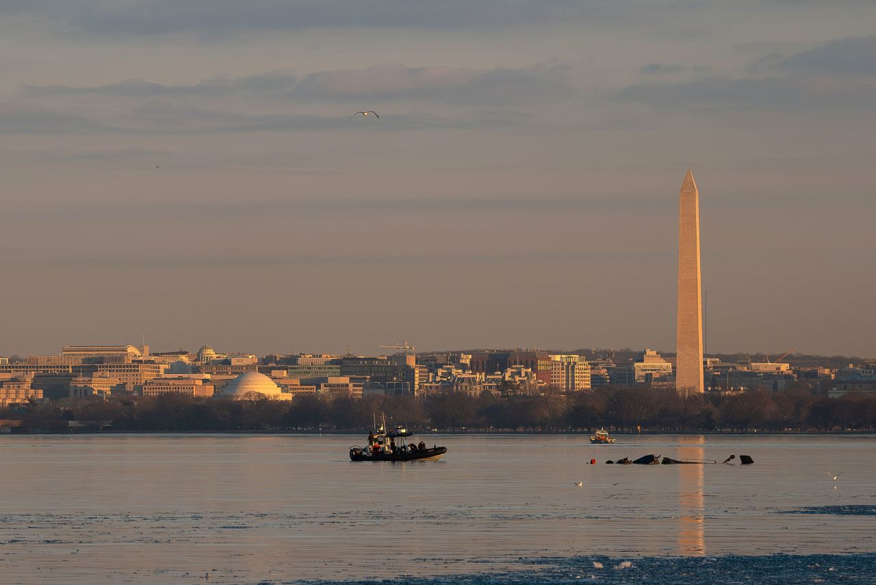 The Washington Monument is seen as US Coast Guard vessels work the scene of the wreckage on Thursday.