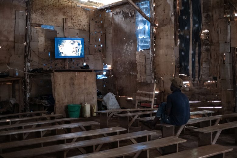 A man watches a movie at an informal cinema hall in Uganda in 2025. Across the African continent, there were just <a  target="_top" href="/newspapers?url=https://www.unesco.org/creativity/sites/default/files/medias/fichiers/2023/01/379165eng.pdf" target="_blank">1,653 cinemas</a> in 2019.