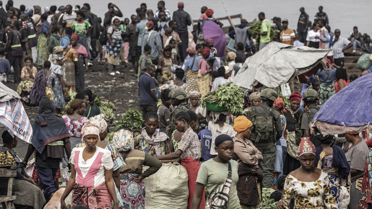 Sellers and residents move through a market under the supervision of members of the M23 armed group at a port along Lake Kivu as the community gradually returns to the streets in Goma on January 31, 2025.