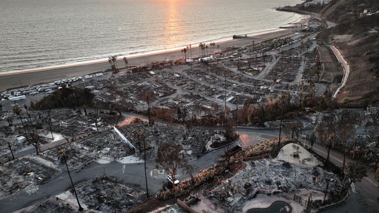 PACIFIC PALISADES, CALIFORNIA - JANUARY 27: An aerial view shows homes destroyed in the Palisades Fire as the sun sets on January 27, 2025 in Pacific Palisades, California. Rain and snowfall across Southern California has temporarily tamed the threat of major wildfires in the region. Multiple wildfires fueled by intense Santa Ana Winds burned across Los Angeles County leaving at least 28 dead with over 180,000 people having been under evacuation orders. Over 12,000 structures, many of them homes and businesses, burned in the Palisades and Eaton Fires. (Photo by Mario Tama/Getty Images)