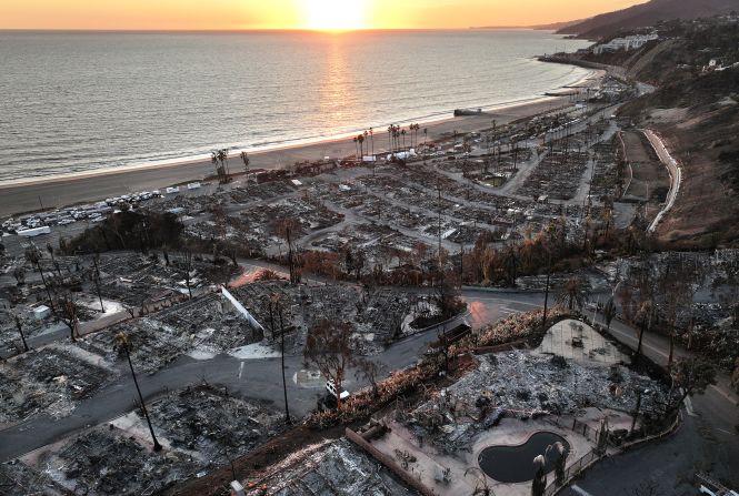 PACIFIC PALISADES, CALIFORNIA - JANUARY 27: An aerial view shows homes destroyed in the Palisades Fire as the sun sets on January 27, 2025 in Pacific Palisades, California. Rain and snowfall across Southern California has temporarily tamed the threat of major wildfires in the region. Multiple wildfires fueled by intense Santa Ana Winds burned across Los Angeles County leaving at least 28 dead with over 180,000 people having been under evacuation orders. Over 12,000 structures, many of them homes and businesses, burned in the Palisades and Eaton Fires. (Photo by Mario Tama/Getty Images)