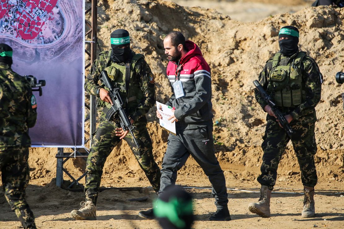 Palestinian militant group Hamas fighters escort Israeli hostage Yarden Bibas before handing him over to a Red Cross team in Khan Yunis on February 1.