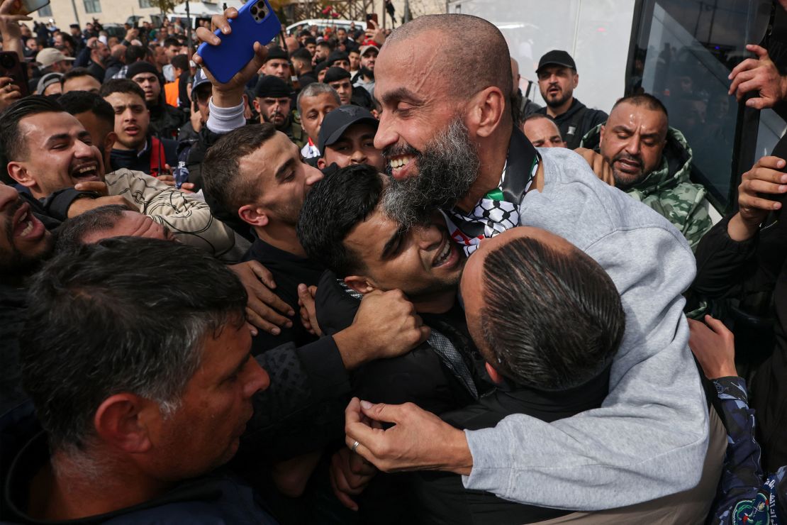 A former Palestinian prisoner released by Israel on Saturday is hugged by family members in Ramallah, in the occupied West Bank.