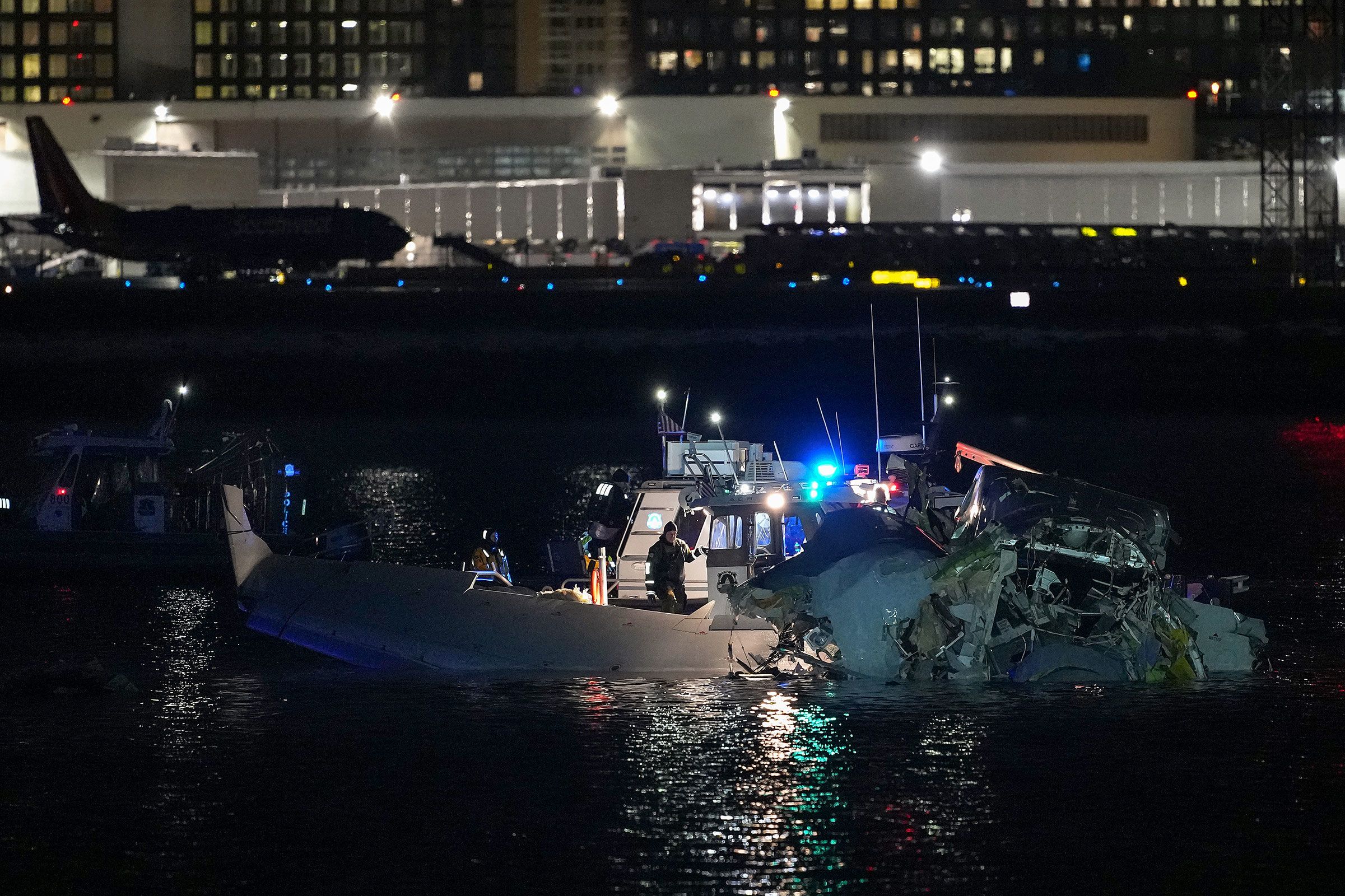 Emergency response units assess airplane wreckage in the Potomac River early on Thursday.