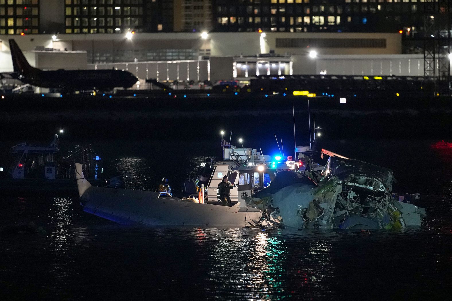 Emergency response units assess airplane wreckage in the Potomac early on Thursday.