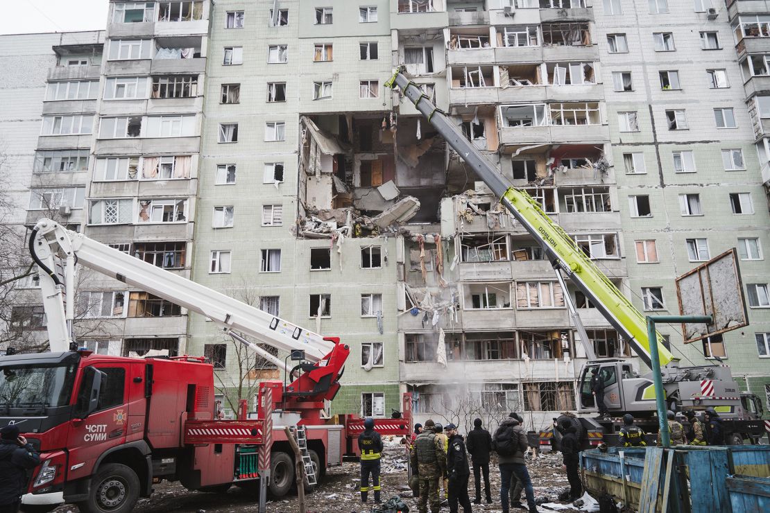 Rescuers clean rubble at a damaged residential building after a Russian drone attack in Sumy.