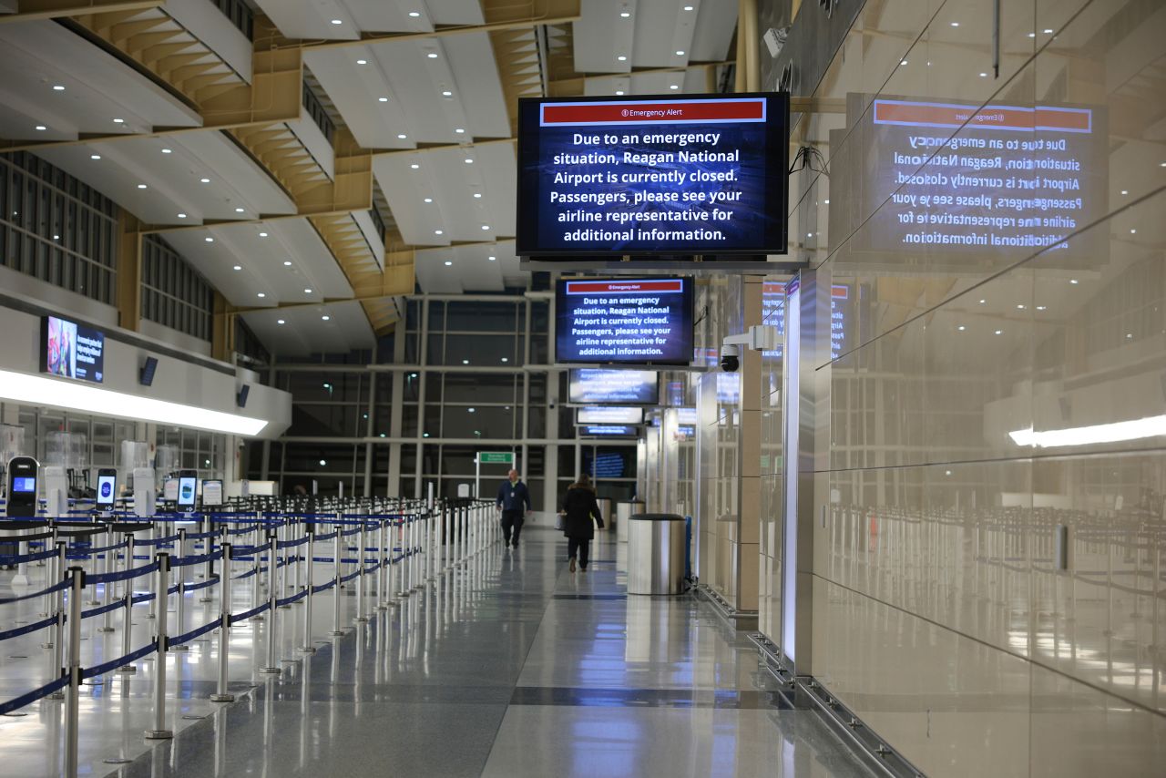 A sign indicates that the Reagan National Airport is currently closed on Thursday, after an American Airlines plane crashed on approach to the airport.