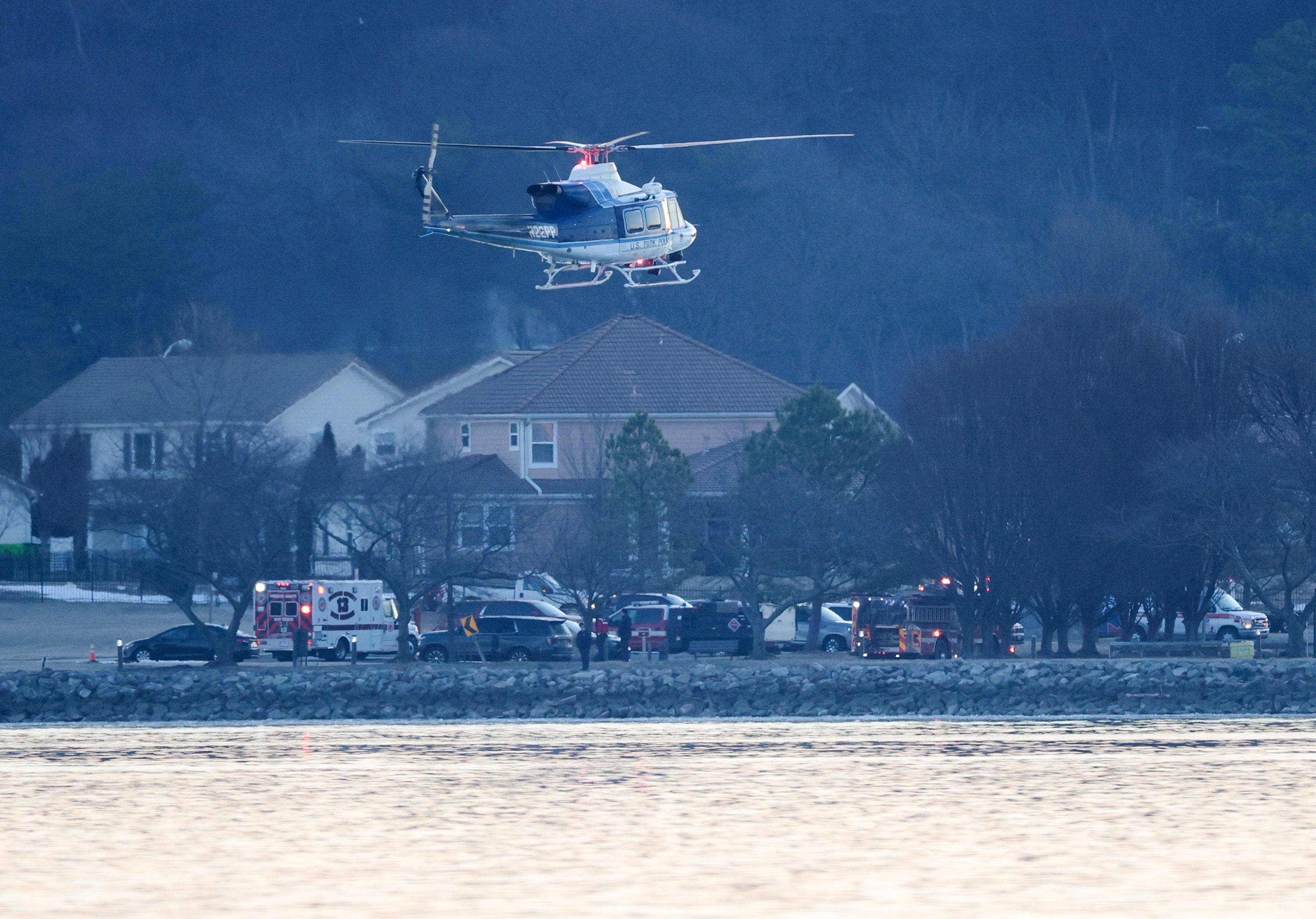 A helicopter flies near the crash site on Thursday.