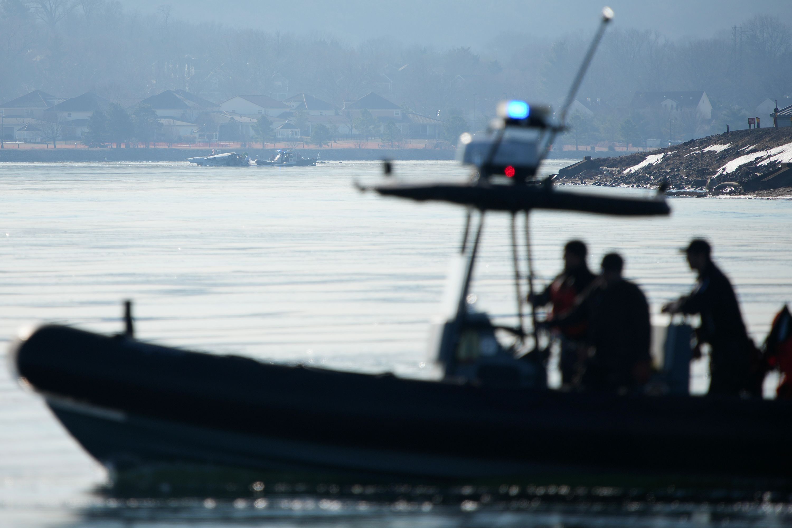 People search the crash site on Thursday.