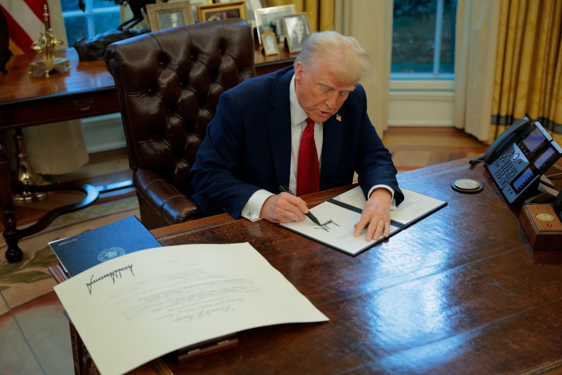 President Donald Trump signs a memorandum at the White House on January 30 ordering an immediate assessment of aviation safety and a rollback of federal DEI policies.