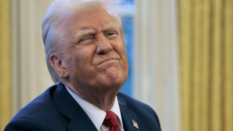 WASHINGTON, DC - JANUARY 30: U.S. President Donald Trump reacts to a reporter's question from the Resolute Desk after g an executive order to appoint the deputy  of the Federal Aviation istration in the Oval Office at the White House on January 30, 2025 in Washington, DC. Trump also signed a memorandum ordering an immediate assessment of aviation safety and ordering an elevation of what he called “competence” over “D.E.I.” (Photo by Chip Somodevilla/Getty Images)