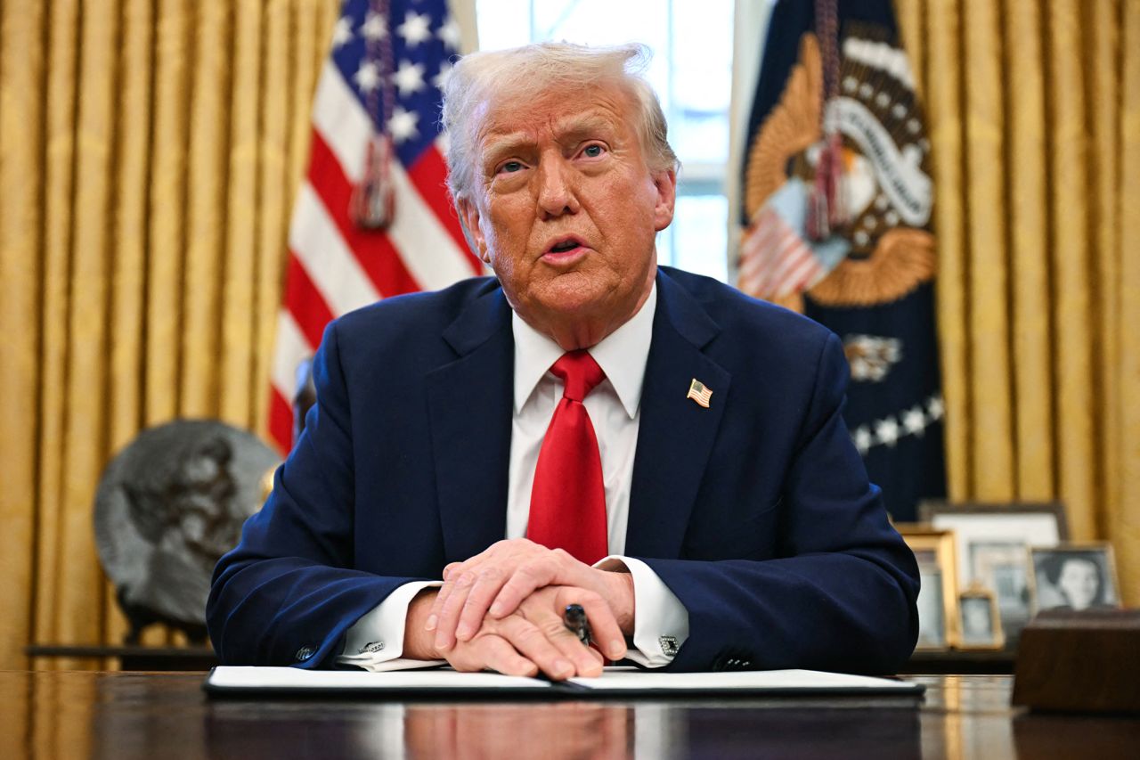 Donald Trump speaks to the press as he signs an executive order at the Oval Office of the White House in Washington, DC., on February 3.