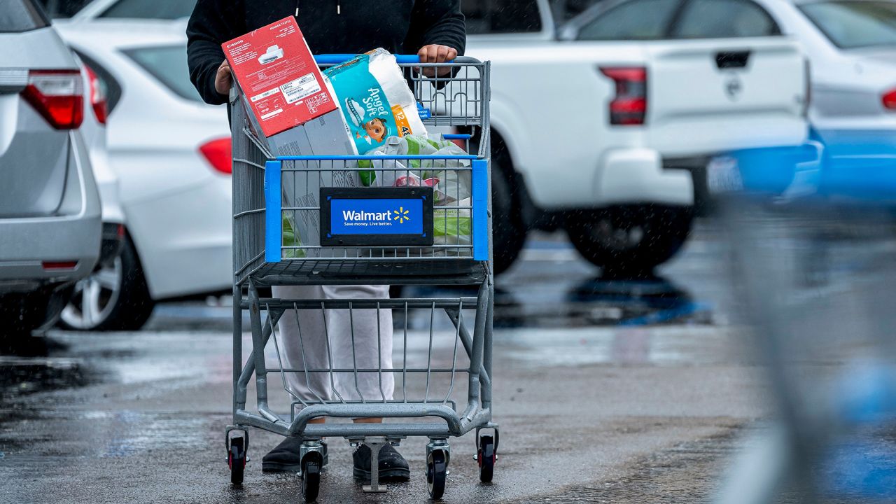 A customer pushes a shopping cart outside a Walmart store in Richmond, California, on Tuesday, Feb. 4, 2025. Around 40% of Walmart’s merchandise is imported, while roughly half of Target’s and Home Depot’s products come from overseas.