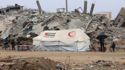 A UAE AID tent stands in front of a collapsed building at Saftawi street in Jabalia in the northern Gaza Strip on February 5, 2025, during a ceasefire deal in the war between Israel and Hamas. Palestinian militant group Hamas lashed out on February 5, at President Donald Trump's shock proposal for the United States to take over the Gaza Strip and resettle its people in other countries, seemingly whether they want to leave or not. (Photo by Omar AL-QATTAA / AFP) (Photo by OMAR AL-QATTAA/AFP via Getty Images)          