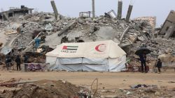 A UAE AID tent stands in front of a collapsed building at Saftawi street in Jabalia in the northern Gaza Strip on February 5, 2025, during a ceasefire deal in the war between Israel and Hamas. Palestinian militant group Hamas lashed out on February 5, at President Donald Trump's shock proposal for the United States to take over the Gaza Strip and resettle its people in other countries, seemingly whether they want to leave or not. (Photo by Omar AL-QATTAA / AFP) (Photo by OMAR AL-QATTAA/AFP via Getty Images)          
