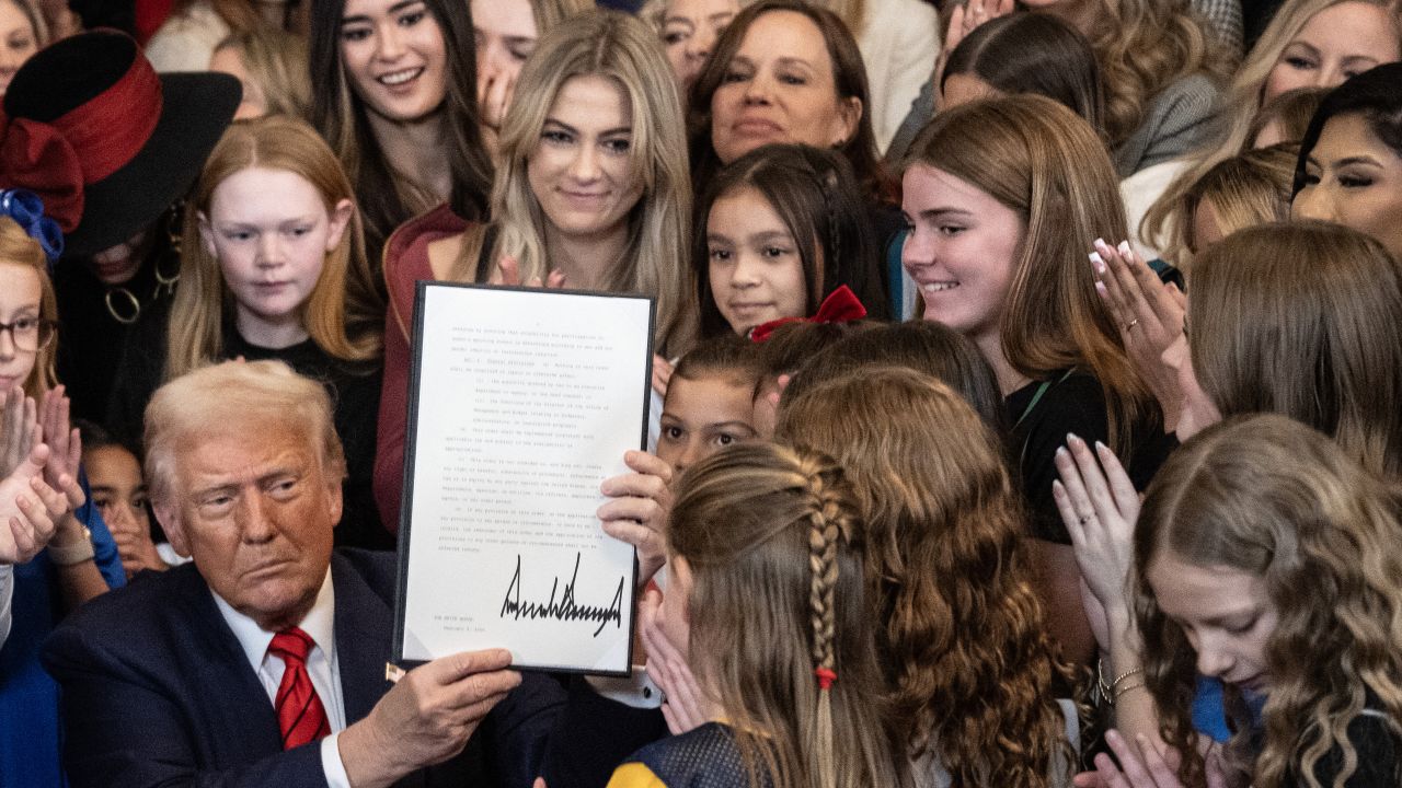 US President Donald Trump holds up the No Men in Women's Sports Executive Order after g it in the East Room of the White House in Washington, DC, on February 5, 2025. President Trump on Wednesday is g an executive order to ban transgender girls and women from competing on sports teams that match their gender identity, marking his latest move targeting transgender rights. (Photo by ANDREW CABALLERO-REYNOLDS / AFP) (Photo by ANDREW CABALLERO-REYNOLDS/AFP via Getty Images)          