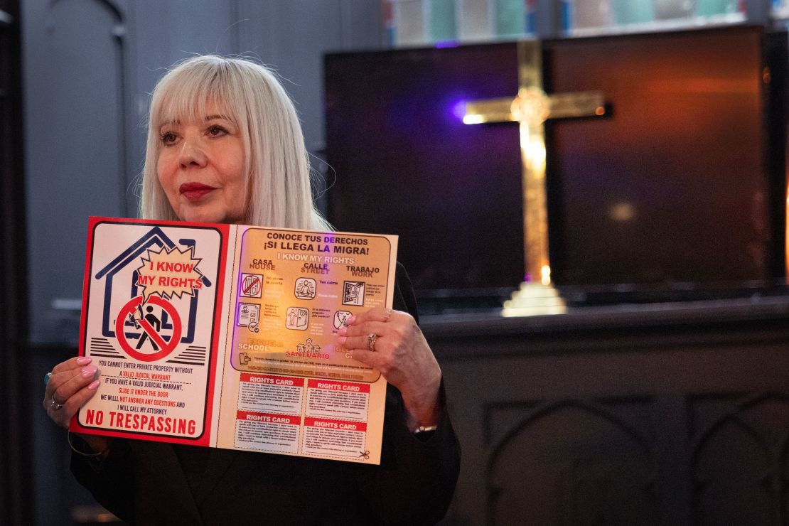 Lozano holds up a "know your rights" card, advising congregants on what they should do if immigration authorities come to their homes.