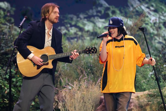 Billie Eilish and her brother, Finneas, <a  target="_top" href="/newspapers?url=https://www.cnn.com/entertainment/live-news/the-grammys-award-show-02-2-25#cm6ocj2km000l3b6m4x8y1idn">perform "Birds of a Feather"</a> near the start of the show.