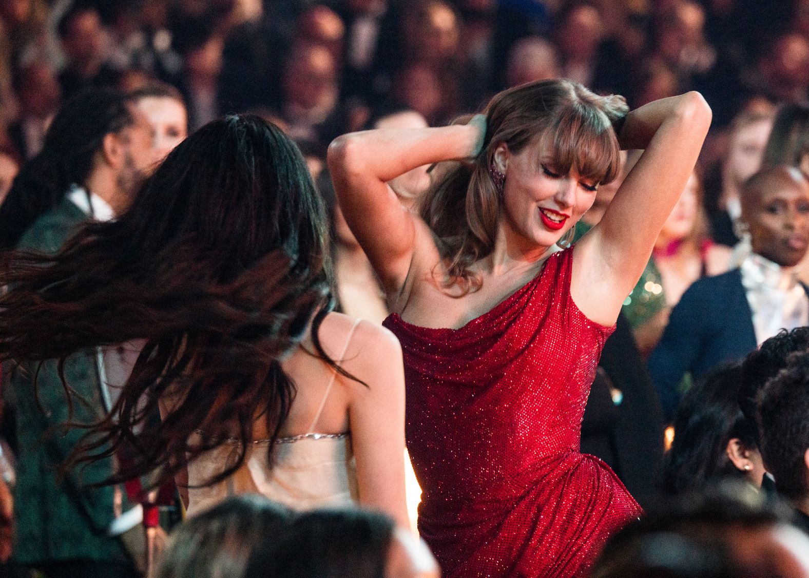 Taylor Swift dances in the audience while enjoying the show at the Crypto.com Arena.