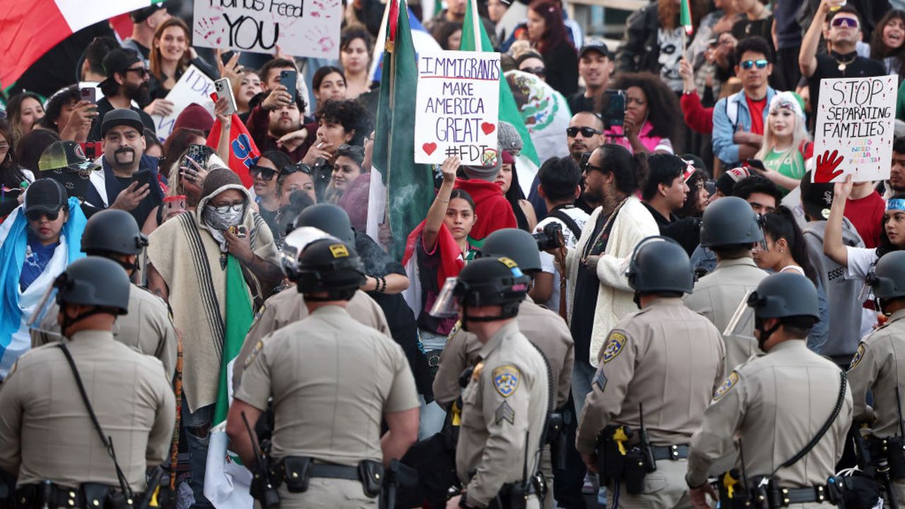 LOS ANGELES, CALIFORNIA - FEBRUARY 02: Anti-deportation demonstrators protest the Trump istration's deportations near police officers blocking an entrance to the 101 freeway on February 02, 2025 in Los Angeles, California. Thousands marched and protested against Immigration and Customs Enforcement (ICE) and mass deportations in downtown Los Angeles, blocking the 101 freeway multiple times and creating gridlock in the area. (Photo by Mario Tama/Getty Images)