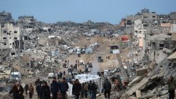 Displaced Palestinians walk through a muddy road amid the destruction in Jabalia in the northern Gaza Strip on February 6, 2025, during a truce in the war between Israel and Hamas. In hunger-stricken makeshift shelters set up in former schools, bombed-out houses and cemeteries across the Gaza Strip, devastated by 15 months of war between Hamas and Israel, hundreds of thousands lack even plastic sheeting to protect from winter rains and biting winds, aid workers say. (Photo by Bashar TALEB / AFP) (Photo by BASHAR TALEB/AFP via Getty Images)          
