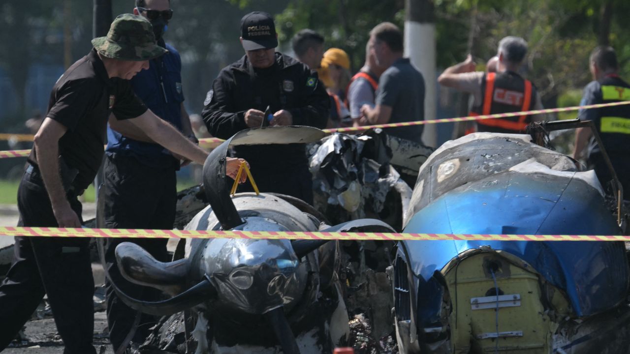 Police investigadors work at the site of a plane accident in Sao Paulo, Brazil, on February 7, 2025. A plane plunged into a major avenue in the Brazilian city of Sao Paulo on Friday and exploded after hitting a bus, leaving two people dead and six injured, officials said. (Photo by NELSON ALMEIDA / AFP) (Photo by NELSON ALMEIDA/AFP via Getty Images)