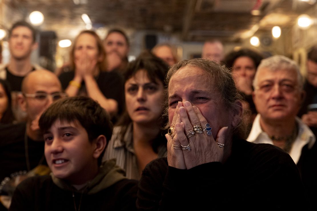 Ohad Ben Ami's relatives react as he appears on stage during a handover ceremony.