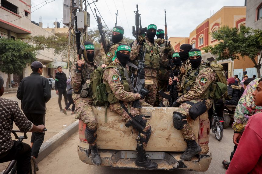 Hamas fighters patrol a street in Deir el-Balah, Gaza, on February 8.