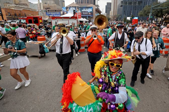 Eagles fans follow a brass band up New Orleans' Poydras Street before the game.