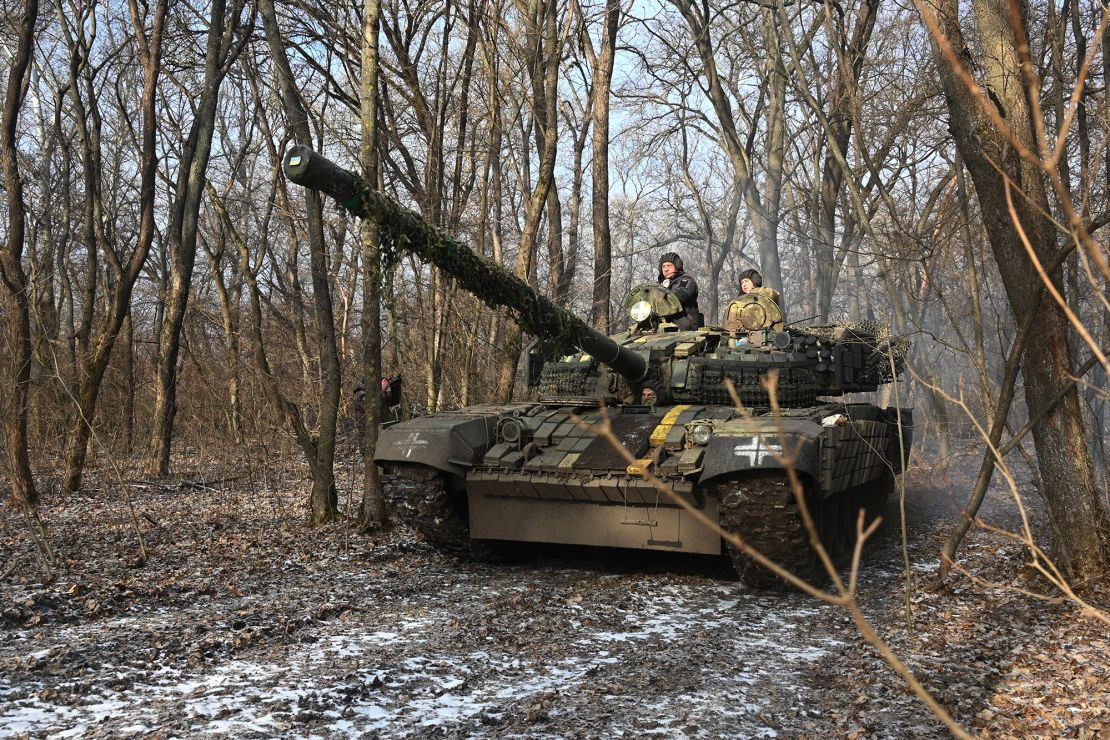 Ukrainian servicemen ride on top of a T-72 tank in the Kharkiv region on february 10.