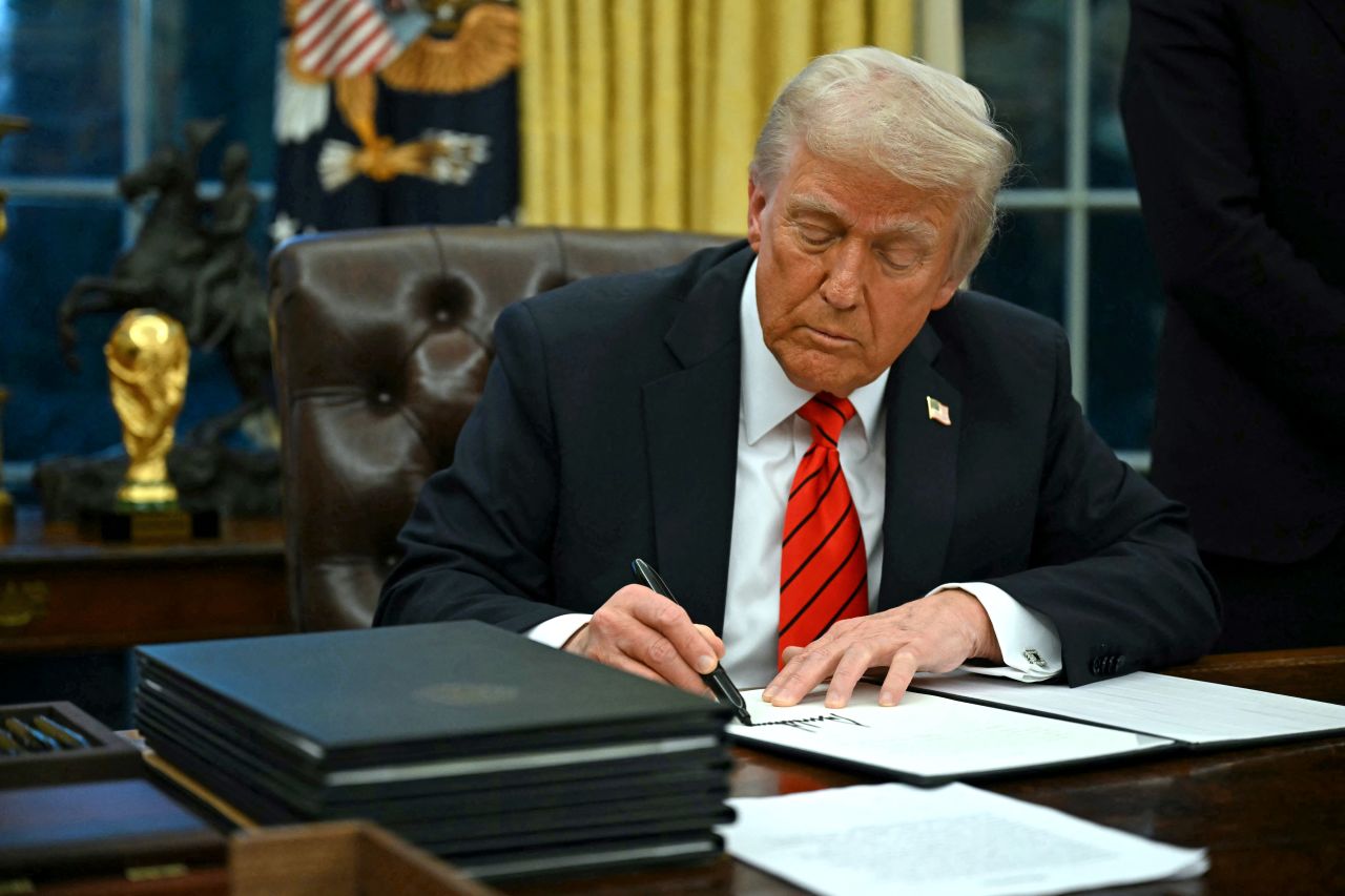 President Donald Trump signs an executive order in the Oval Office of the White House in Washington, DC, on Monday.