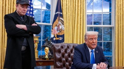 Elon Musk listens as US President Donald Trump speaks in the Oval Office of the White House in Washington, DC, on February 11, 2025. Tech billionaire Elon Musk, who has been tapped by President Donald Trump to lead federal cost-cutting efforts, said the United States would go "bankrupt" without budget cuts. Musk leads the efforts under the newly created Department of Government Efficiency (DOGE), and was speaking at the White House with Trump, who has in recent weeks unleashed a flurry of orders aimed at slashing federal spending. (Photo by Jim WATSON / AFP) (Photo by JIM WATSON/AFP via Getty Images)          