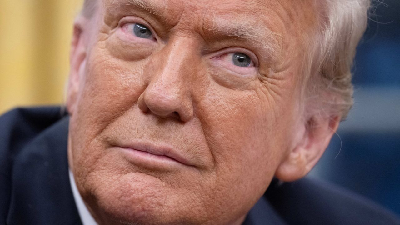 US President Donald Trump looks on as Elon Musk speaks in the Oval Office of the White House in Washington, DC, on February 11, 2025. Tech billionaire Elon Musk, who has been tapped by President Donald Trump to lead federal cost-cutting efforts, said the United States would go "bankrupt" without budget cuts. Musk leads the efforts under the newly created Department of Government Efficiency (DOGE), and was speaking at the White House with Trump, who has in recent weeks unleashed a flurry of orders aimed at slashing federal spending. (Photo by Jim WATSON / AFP)