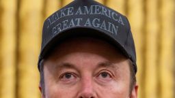 TOPSHOT - Tesla and SpaceX CEO Elon Musk looks on before US President Donald Trump signs executive orders in the Oval Office of the White House in Washington, DC, on February 11, 2025. Tech billionaire Elon Musk, who has been tapped by President Donald Trump to lead federal cost-cutting efforts, said the United States would go "bankrupt" without budget cuts. Musk leads the efforts under the newly created Department of Government Efficiency (DOGE), and was speaking at the White House with Trump, who has in recent weeks unleashed a flurry of orders aimed at slashing federal spending. (Photo by Jim WATSON / AFP) (Photo by JIM WATSON/AFP via Getty Images)          