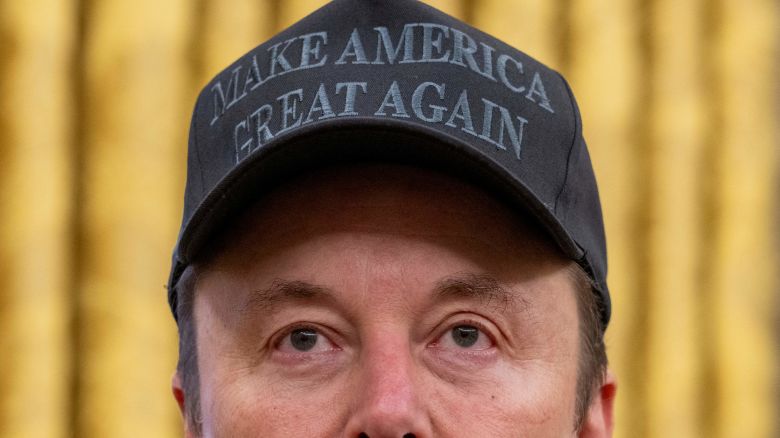 TOPSHOT - Tesla and SpaceX CEO Elon Musk looks on before US President Donald Trump signs executive orders in the Oval Office of the White House in Washington, DC, on February 11, 2025. Tech billionaire Elon Musk, who has been tapped by President Donald Trump to lead federal cost-cutting efforts, said the United States would go "bankrupt" without budget cuts. Musk leads the efforts under the newly created Department of Government Efficiency (DOGE), and was speaking at the White House with Trump, who has in recent weeks unleashed a flurry of orders aimed at slashing federal spending. (Photo by Jim WATSON / AFP) (Photo by JIM WATSON/AFP via Getty Images)          