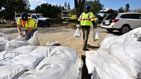 Sandbags are loaded into the trunk of a woman's car on February 11, 2025 in Pasadena, California, as the National Weather Service warns that heavy rains could cause flooding in the coming days. California is gearing up for its strongest storm of the winter, raising fears of flooding and landslides in the burnt-out areas around Los Angeles in January. Between Wednesday February 12 and Friday February 14, the southern part of the state will receive up to 15 cm of precipitation in places, according to the US Weather Service (NWS).