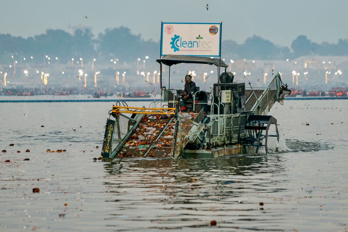 A worker collects waste using a trash skimmer machine on Wednesday, February 12.