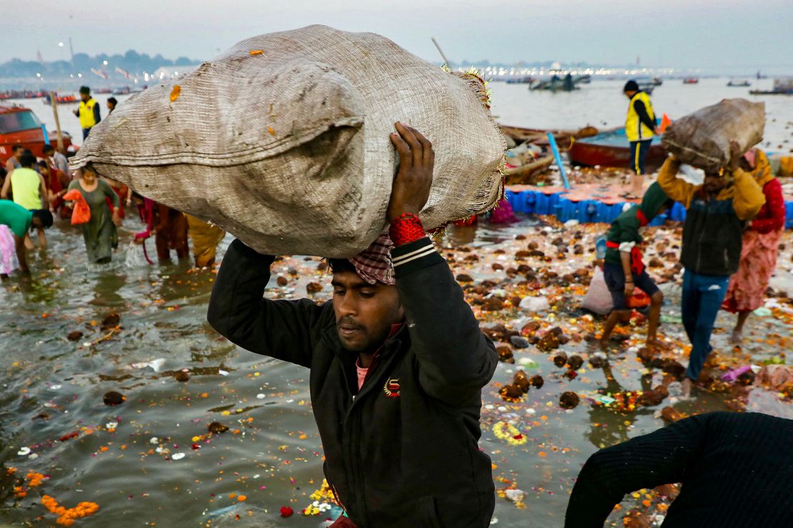 Workers carry sacks of waste in Prayagraj on Wednesday, February 12.