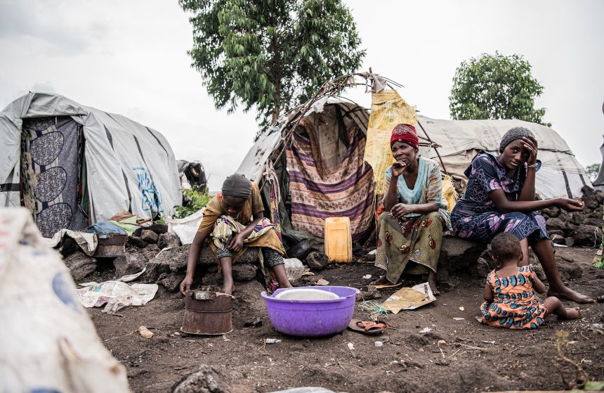 Internally displaced families carry their belongings while leaving a camp in Bulengo, on the outskirts of Goma, on February 12, 2025.