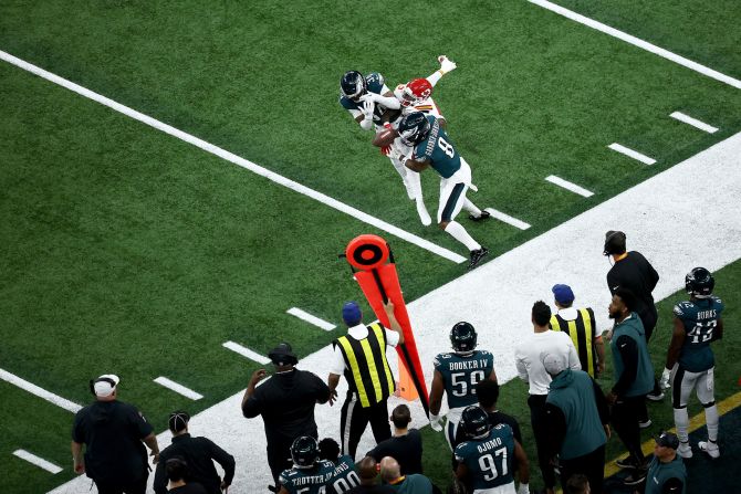 The Eagles' Isaiah Rodgers and C.J. Gardner-Johnson break up a pass intended for Marquise Brown.