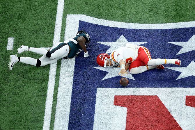 Mahomes reaches for the ball after being tackled in the third quarter.