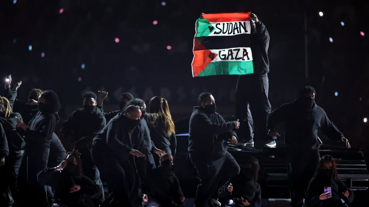 NEW ORLEANS, LOUISIANA - FEBRUARY 09: A protester holds a flag onstage during Apple Music Super Bowl LIX Halftime Show at Caesars Superdome on February 09, 2025 in New Orleans, Louisiana.  (Photo by Emilee Chinn/Getty Images)