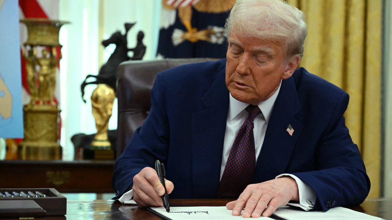 TOPSHOT - US President Donald Trump signs an Executive Order on reciprocal tariffs in the Oval Office of the White House in Washington, DC, on February 13, 2025. Trump announced that he would impose "reciprocal tariffs" on trading partners, opening new fronts in his trade war. The move would match US tariff rates on imports to the levels that other countries impose on US goods. (Photo by ANDREW CABALLERO-REYNOLDS / AFP) (Photo by ANDREW CABALLERO-REYNOLDS/AFP via Getty Images)          
