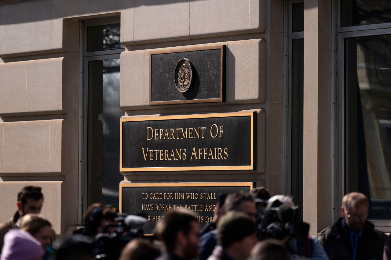 Members of the press stand near a rally outside the Department of Veterans Affairs headquarters in Washington, DC, on February 13.