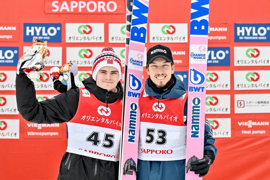 Marius Lindvik (left) and Johann André Forfang stand on the podium at the Ski Jumping World Cup competition in Sapporo, Japan in February.