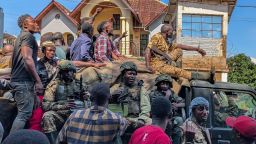 Residents walk next to a vehicle with M23 fighters on in Bukavu, February 16, 2025.