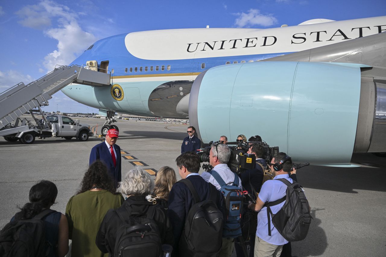 President Donald Trump speaks to reporters after landing at Palm Beach International Airport in West Palm Beach, Florida, on Sunday.