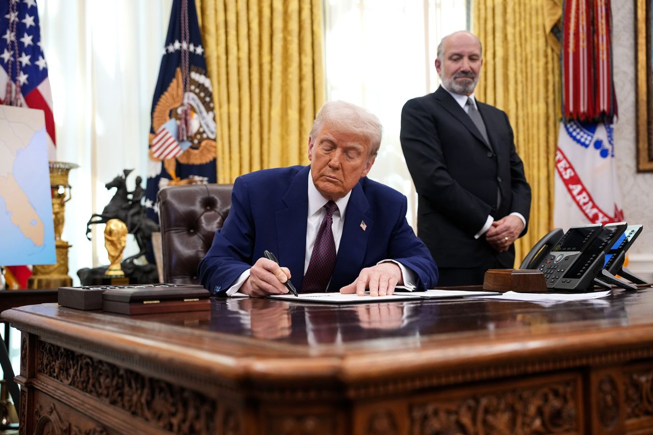 President Donald Trump signs an executive order at the White House on Thursday.